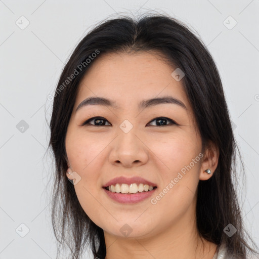 Joyful asian young-adult female with long  brown hair and brown eyes