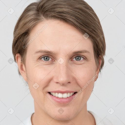 Joyful white young-adult female with short  brown hair and grey eyes