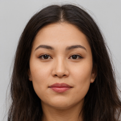 Joyful latino young-adult female with long  brown hair and brown eyes