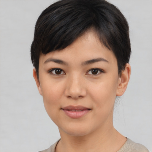 Joyful asian young-adult female with short  black hair and brown eyes