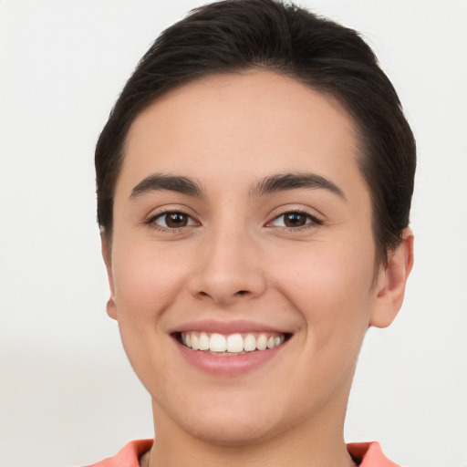 Joyful white young-adult female with short  brown hair and brown eyes