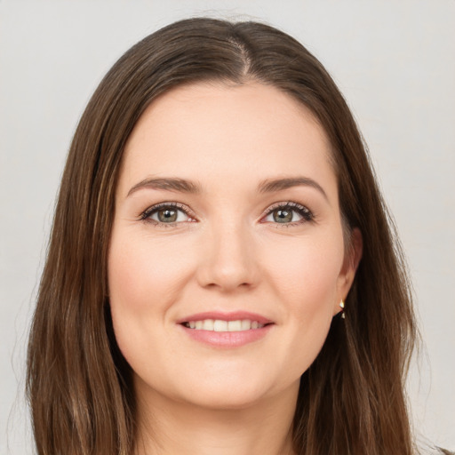 Joyful white young-adult female with long  brown hair and brown eyes