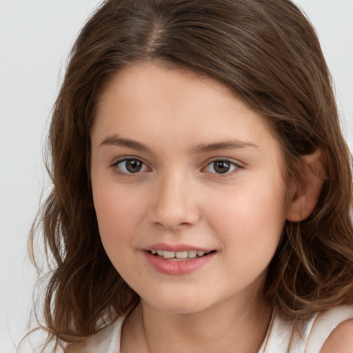 Joyful white child female with long  brown hair and brown eyes