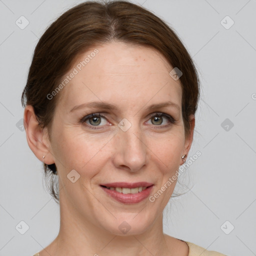 Joyful white adult female with medium  brown hair and grey eyes