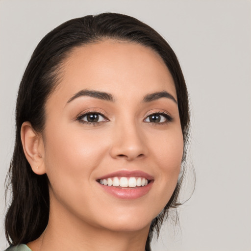 Joyful white young-adult female with long  brown hair and brown eyes