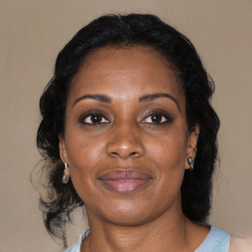 Joyful black adult female with medium  black hair and brown eyes