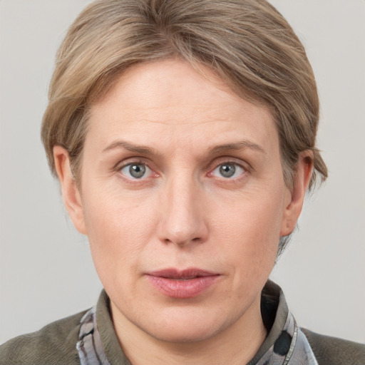 Joyful white adult female with short  brown hair and grey eyes