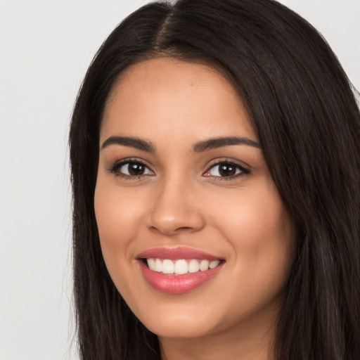 Joyful white young-adult female with long  black hair and brown eyes