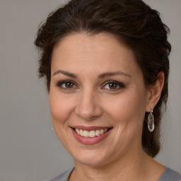 Joyful white adult female with medium  brown hair and brown eyes