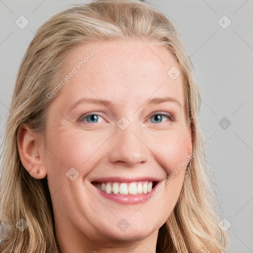 Joyful white young-adult female with long  brown hair and blue eyes