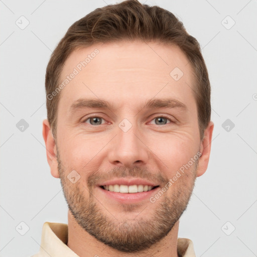 Joyful white young-adult male with short  brown hair and grey eyes