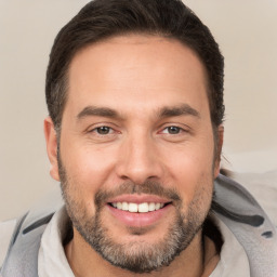 Joyful white adult male with short  brown hair and brown eyes