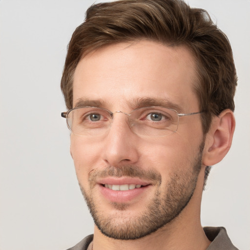 Joyful white adult male with short  brown hair and grey eyes