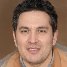 Joyful white adult male with short  brown hair and brown eyes