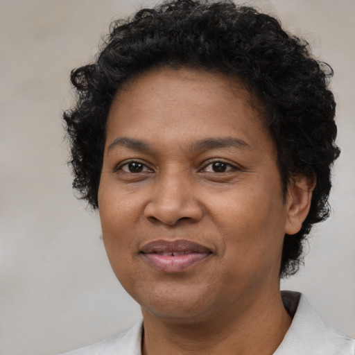 Joyful black adult female with short  brown hair and brown eyes
