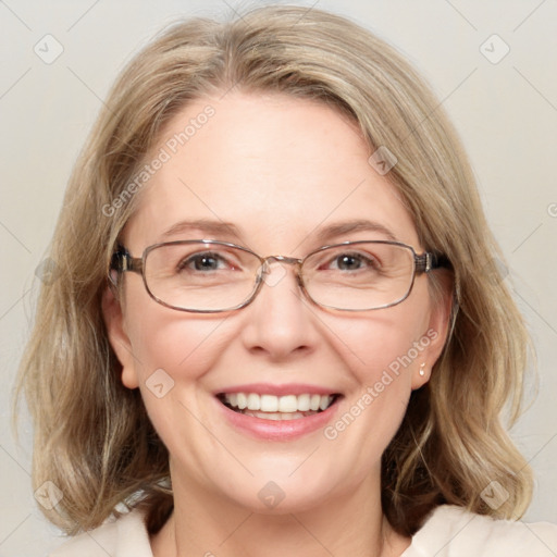 Joyful white adult female with medium  brown hair and blue eyes