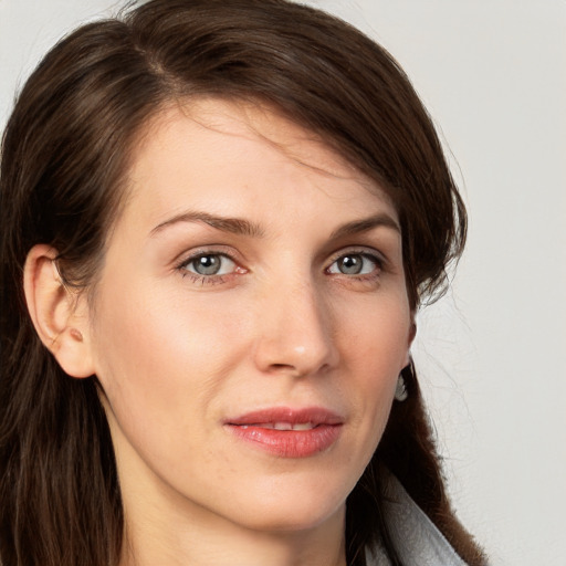 Joyful white young-adult female with long  brown hair and blue eyes