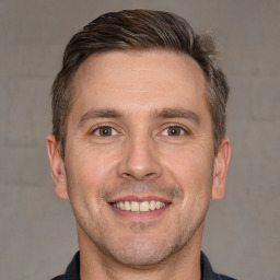 Joyful white adult male with short  brown hair and brown eyes