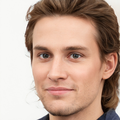 Joyful white young-adult male with medium  brown hair and grey eyes