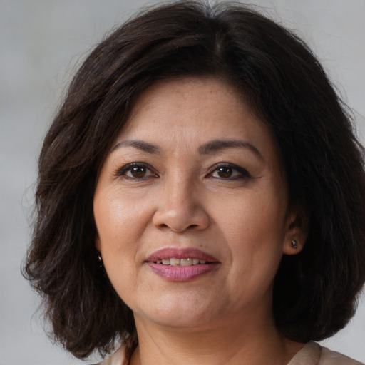 Joyful white adult female with medium  brown hair and brown eyes