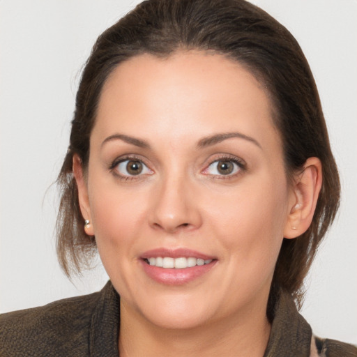 Joyful white adult female with medium  brown hair and brown eyes