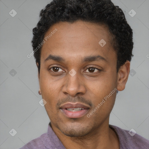 Joyful black adult male with short  black hair and brown eyes