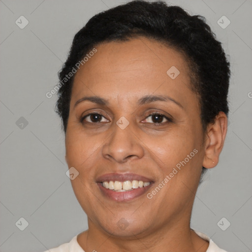 Joyful latino adult female with short  brown hair and brown eyes