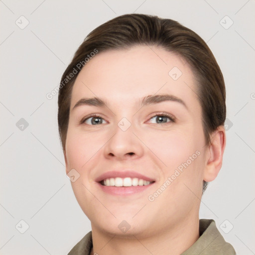 Joyful white young-adult female with short  brown hair and grey eyes