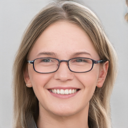 Joyful white young-adult female with long  brown hair and blue eyes