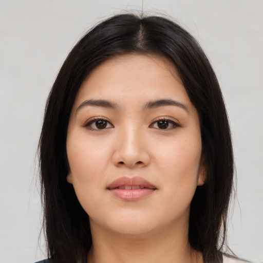 Joyful latino young-adult female with long  brown hair and brown eyes