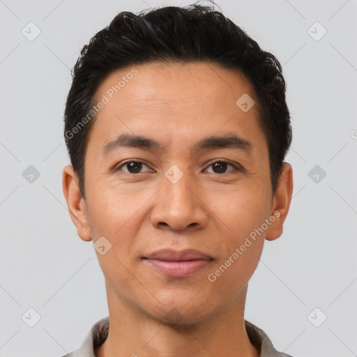 Joyful latino young-adult male with short  brown hair and brown eyes