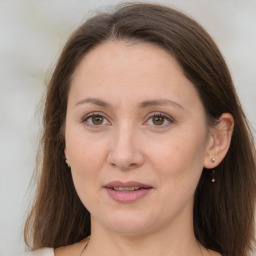 Joyful white adult female with long  brown hair and brown eyes