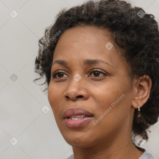 Joyful black adult female with short  brown hair and brown eyes