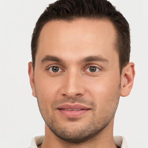 Joyful white young-adult male with short  brown hair and brown eyes