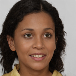 Joyful latino young-adult female with long  brown hair and brown eyes