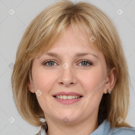 Joyful white adult female with medium  brown hair and blue eyes