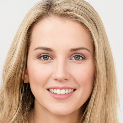 Joyful white young-adult female with long  brown hair and green eyes