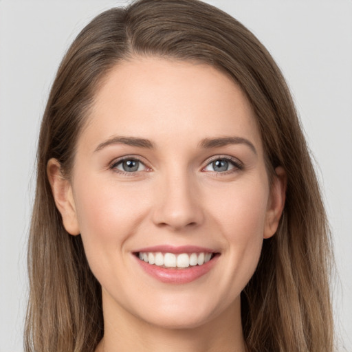 Joyful white young-adult female with long  brown hair and grey eyes