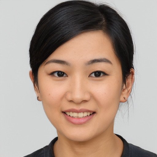 Joyful asian young-adult female with medium  black hair and brown eyes