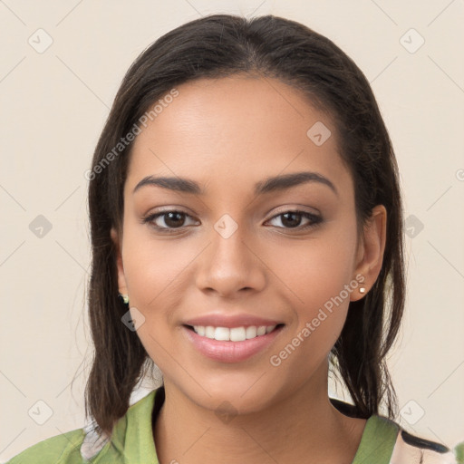 Joyful latino young-adult female with long  brown hair and brown eyes