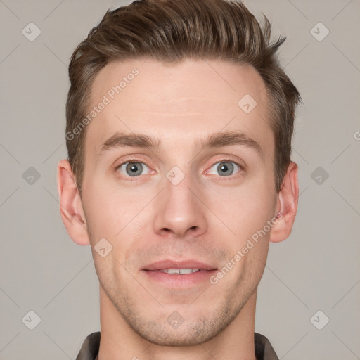 Joyful white young-adult male with short  brown hair and grey eyes