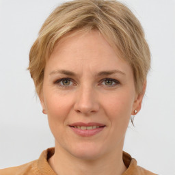 Joyful white adult female with medium  brown hair and grey eyes