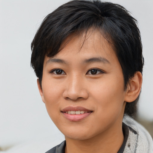Joyful asian young-adult female with short  black hair and brown eyes