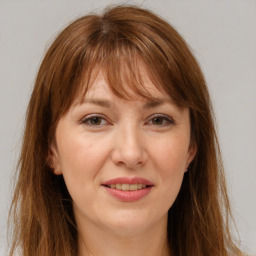 Joyful white adult female with long  brown hair and brown eyes