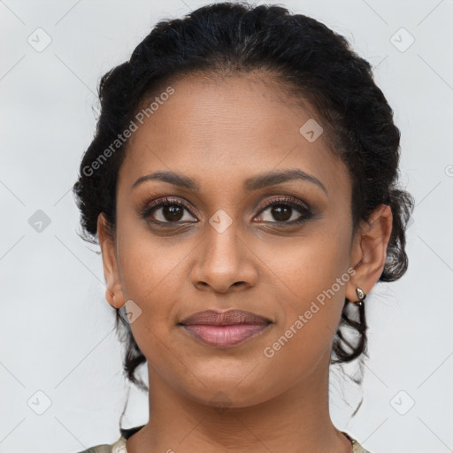 Joyful black young-adult female with medium  brown hair and brown eyes