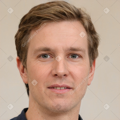 Joyful white adult male with short  brown hair and grey eyes