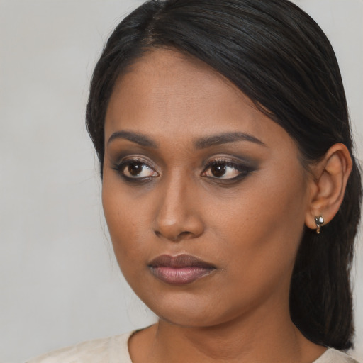 Neutral black young-adult female with long  brown hair and brown eyes