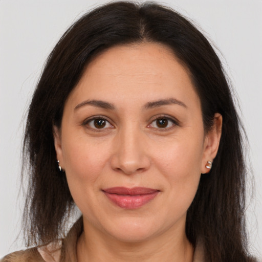 Joyful white adult female with long  brown hair and brown eyes