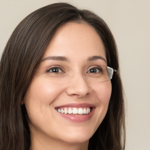 Joyful white young-adult female with long  brown hair and brown eyes