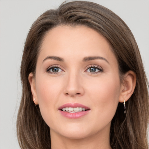 Joyful white young-adult female with long  brown hair and grey eyes